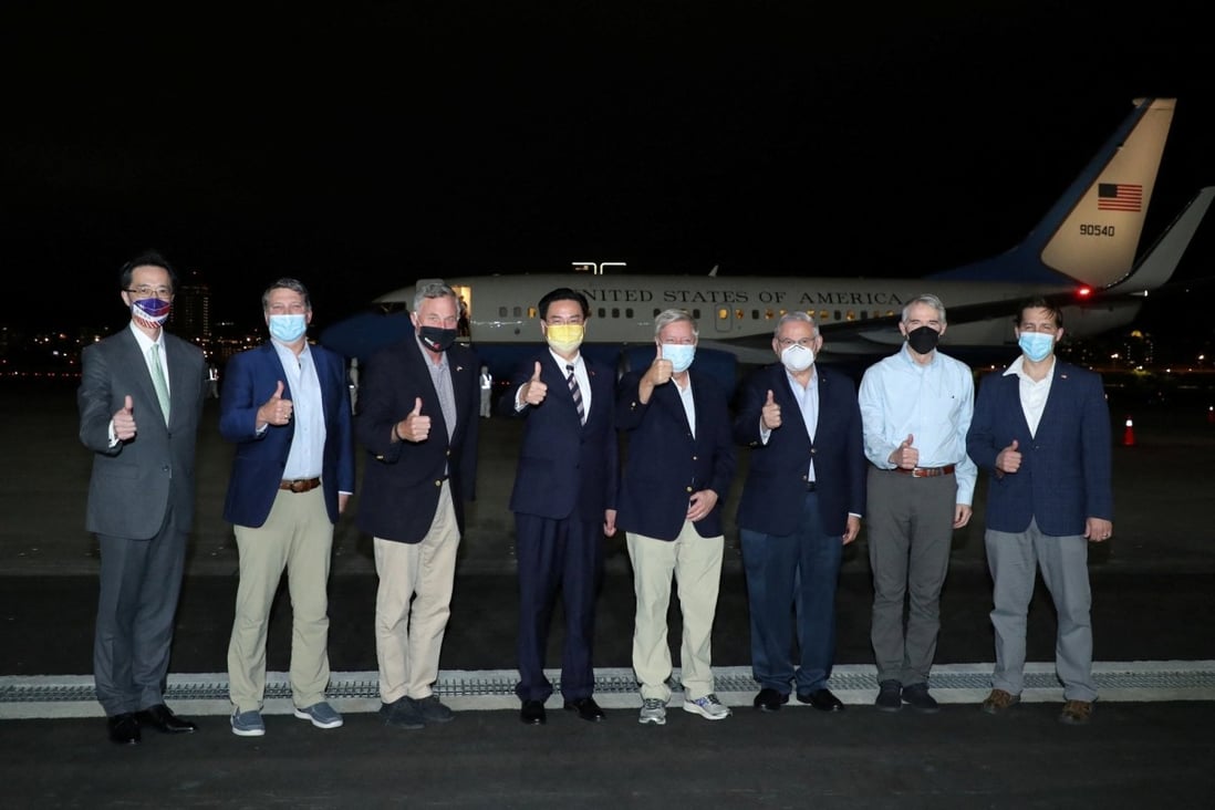Bob Menendez and other members of the US delegation pose with Taiwanese Foreign Minister Joseph Wu (fourth left) at Taipei Songshan airport. Photo: via Reuters