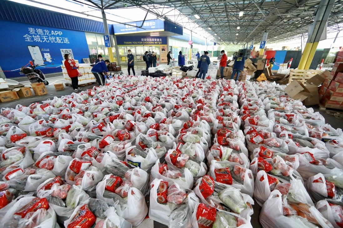 Staff members organise mass food orders from locked down Shanghai residents. Photo: Reuters