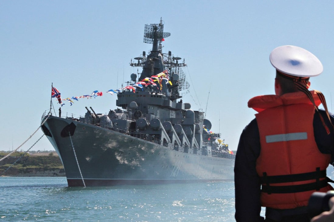 A sailor looks at the Russian missile cruiser Moskva moored in the Black Sea port of Sevastopol in Septembeer 2013. Photo: Reuters 