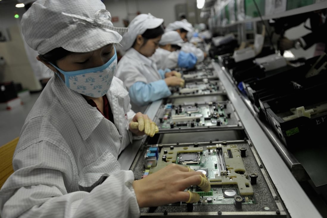 Workers assemble electronic components at a factory of Taiwanese technology giant Foxconn in Shenzhen. Apple’s decision, via Foxconn, to manufacture iPhones in China and its ripple effects are one of a series of “China shocks” that have reshaped the global economic landscape. Photo: AFP