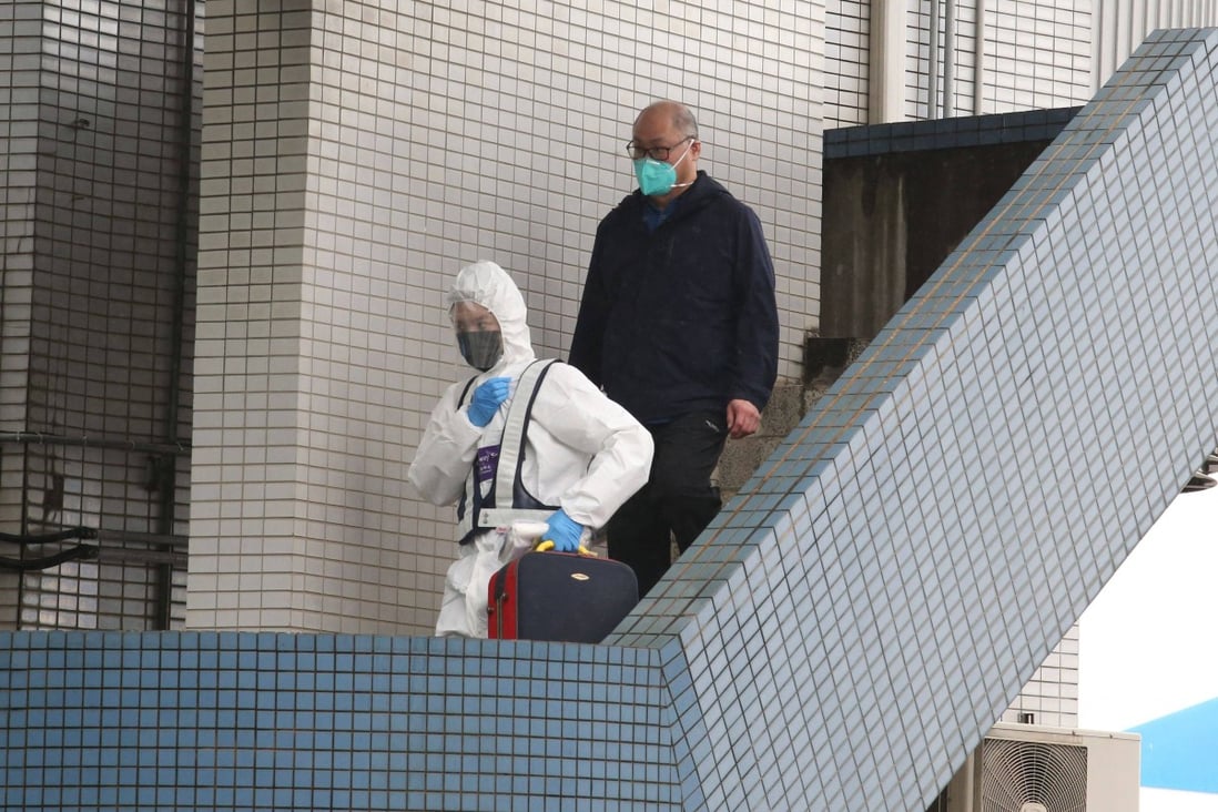 Lee Ming-che is escorted by epidemic prevention personnel after arriving at Taoyuan Airport in Taiwan on Friday. Photo: AFP