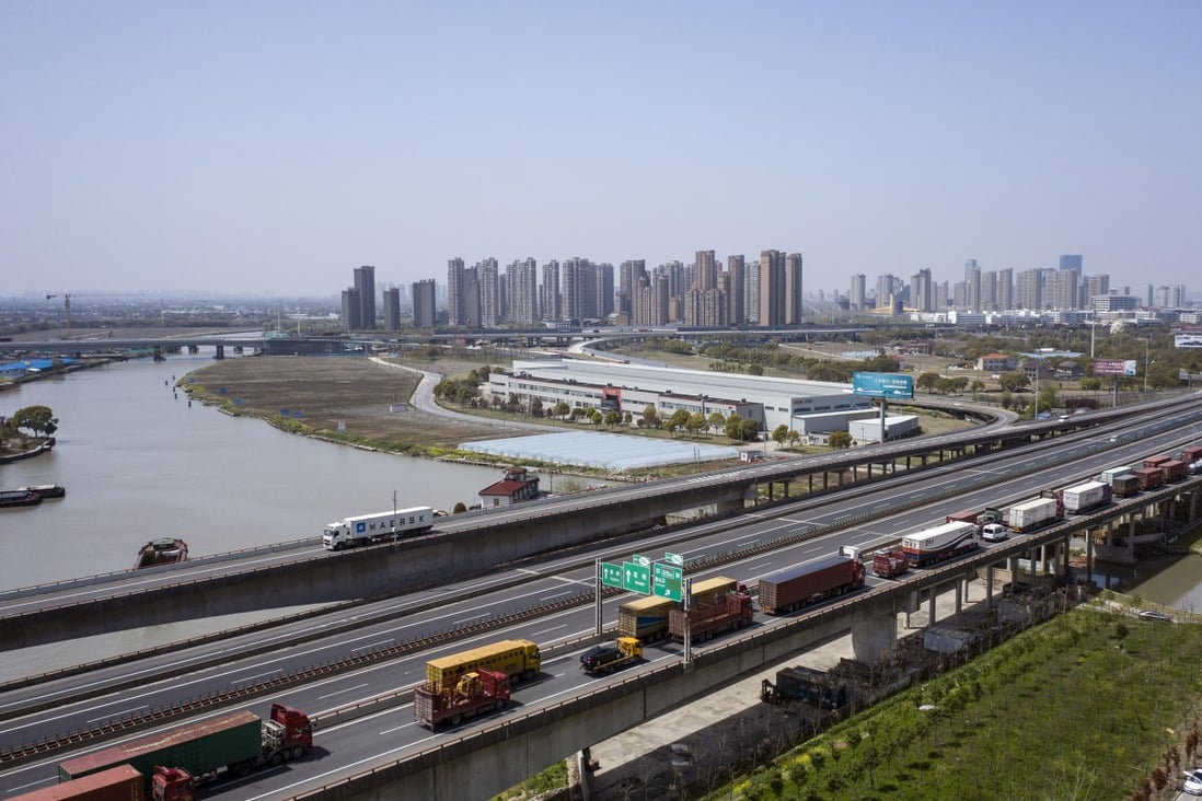 Trucks wait to pass through a checkpoint on a highway in China. Photo: Bloomberg 