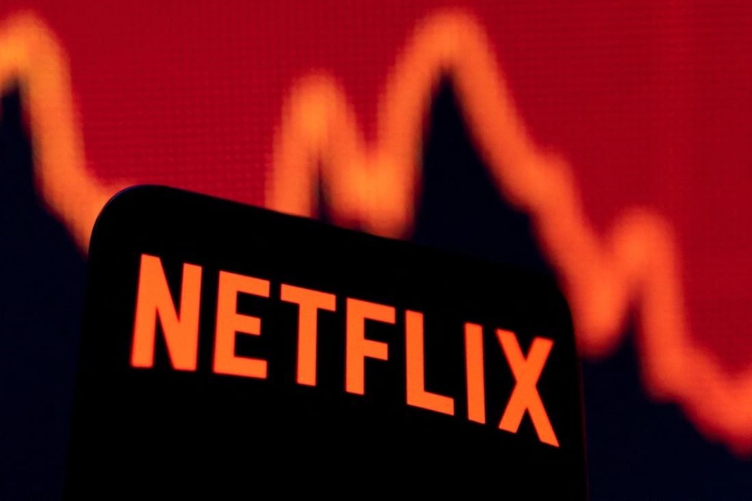 Smartphone with Netflix logo is seen in front of a descending stock graph in this illustration from Tuesday. Photo: Reuters