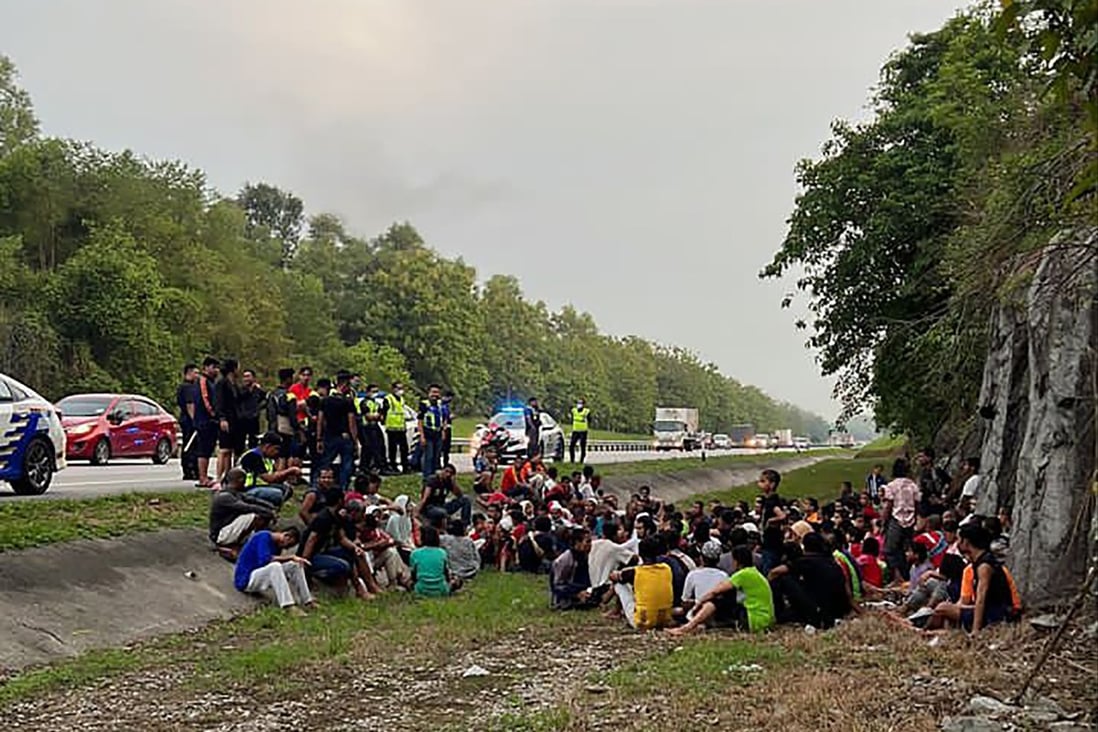 Malaysian police with some of the hundreds of Rohingya refugees who escaped from a detention centre in Penang on Wednesday. Photo: Malaysia Royal Police via AP