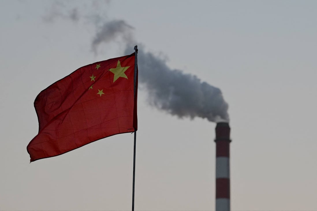 China’s national flag flutters in front of a coal-powered power station in Datong, northern Shanxi province. Photo: AFP