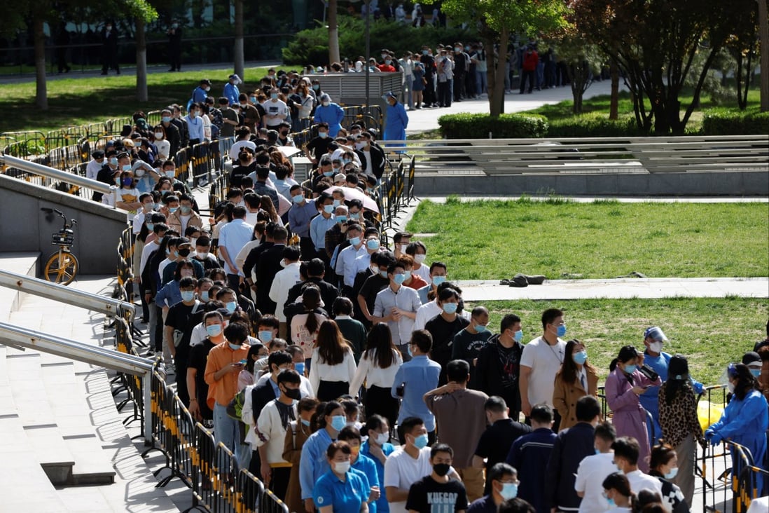 People line up outside a makeshift nucleic acid testing site during a mass Covid-19 detection programme in Haidian district of Beijing on Tuesday. Photo: Reuters