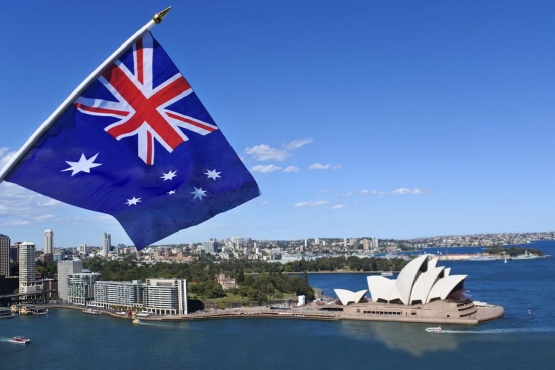The National flag of Australia flies above the Opera house in Sydney Australia. Photo: Shutterstock