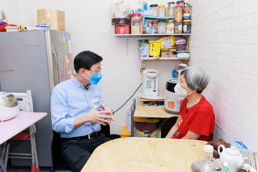 John Lee visits a low-income household in Yau Mei Tai. Lee has promised to tackle deep-rooted problems, like insufficient housing, if elected. Photo: Handout