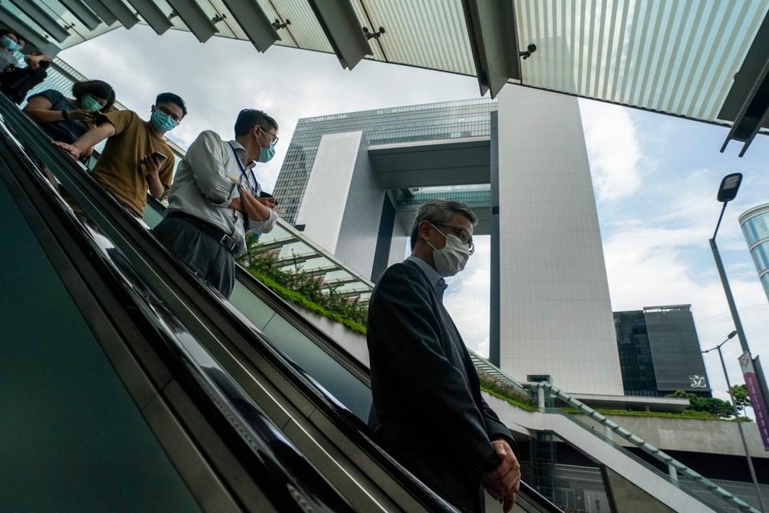 Civil servants are seen outside Central Government Offices in Admiralty. Photo: Felix Wong