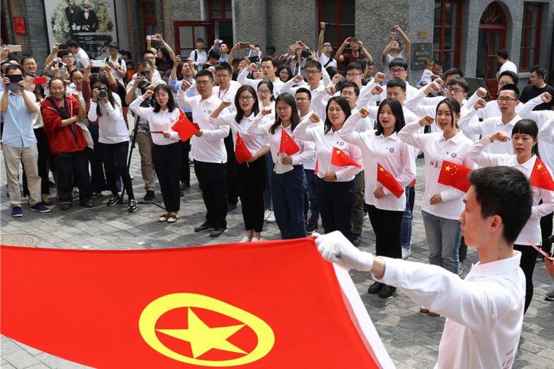 Students from Peking University recite the joining oath of the Communist Youth League in Beijing. Photo: China Daily