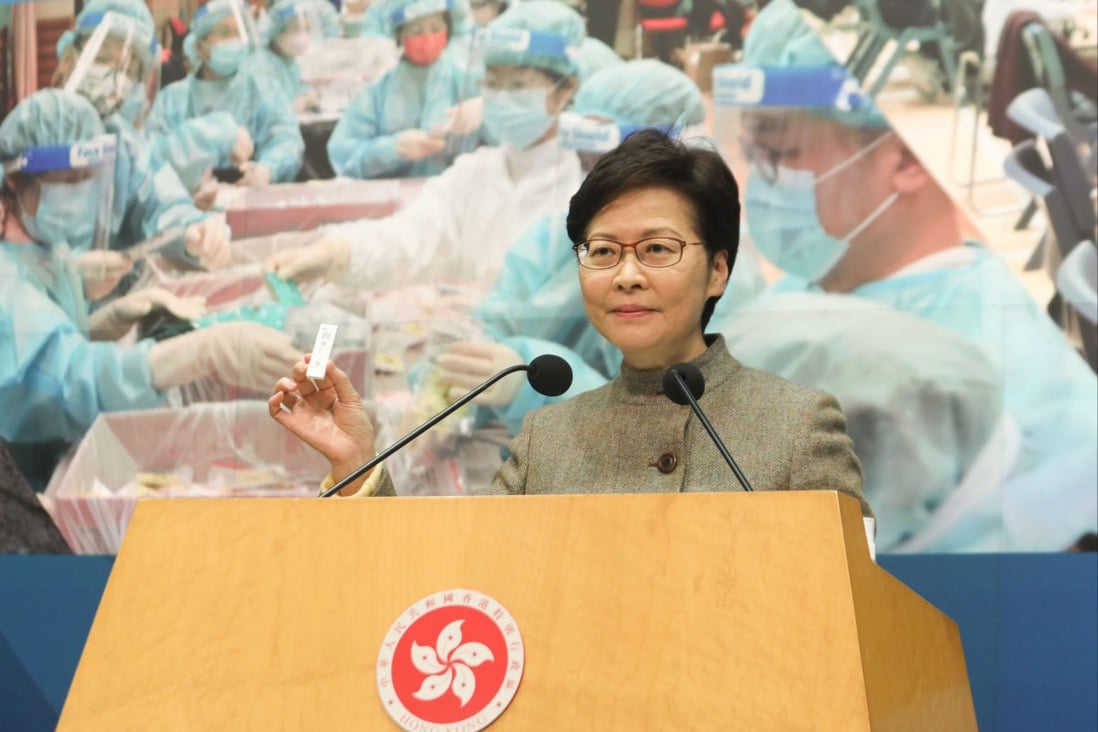 Chief Executive Carrie Lam Cheng Yuet-ngor holds a Covid-19 rapid testing kit at a press conference. Photo: Jelly Tse