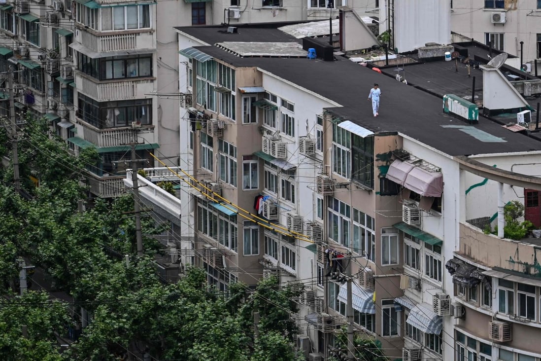 A woman  on the rooftop of a building during a Covid-19 coronavirus lockdown in the Jing’an district in Shanghai on May 11, 2022. Photo: AFP