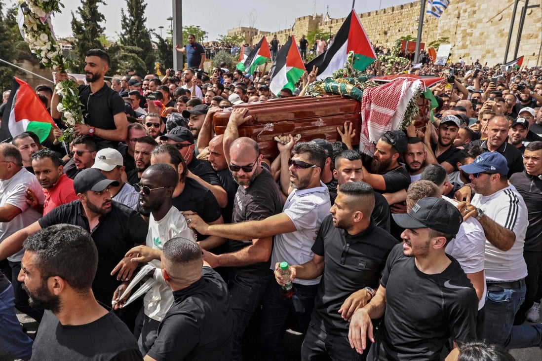 Palestinian mourners carry the casket of slain journalist Shireen Abu Akleh from a church to the cemetery in Jerusalem on Friday. Photo: AFP