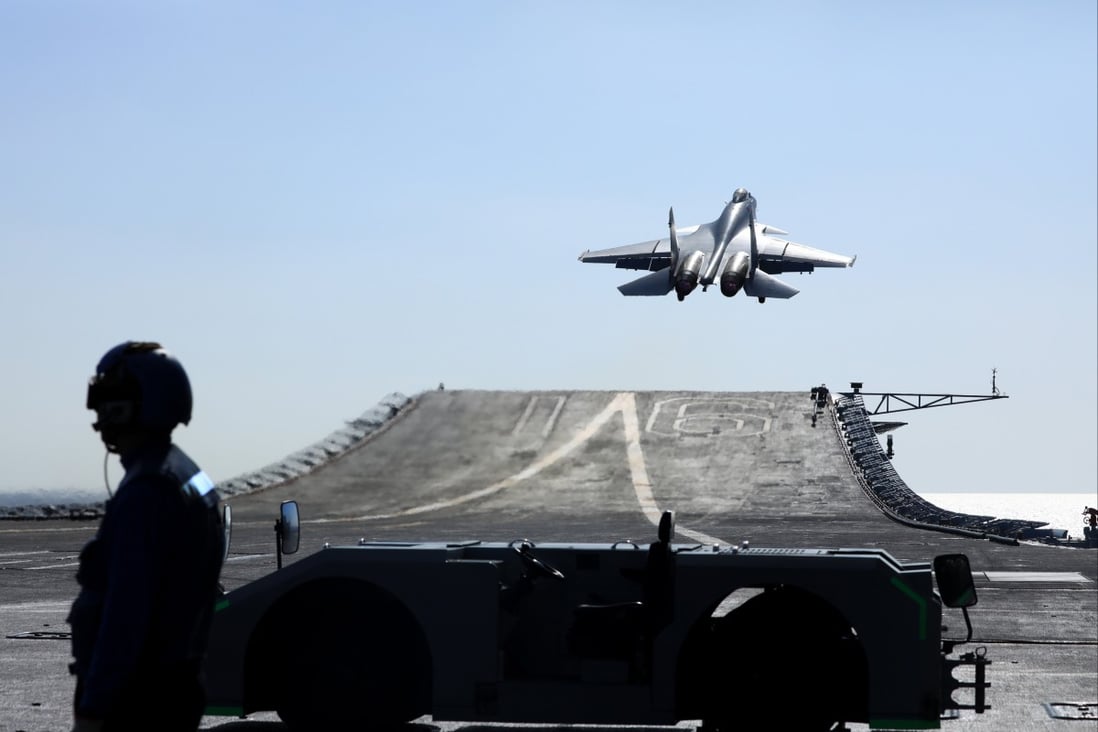 A carrier-based J-15 fighter jet takes off from the Liaoning’s flight deck during open-sea combat training. Photo: Xinhua