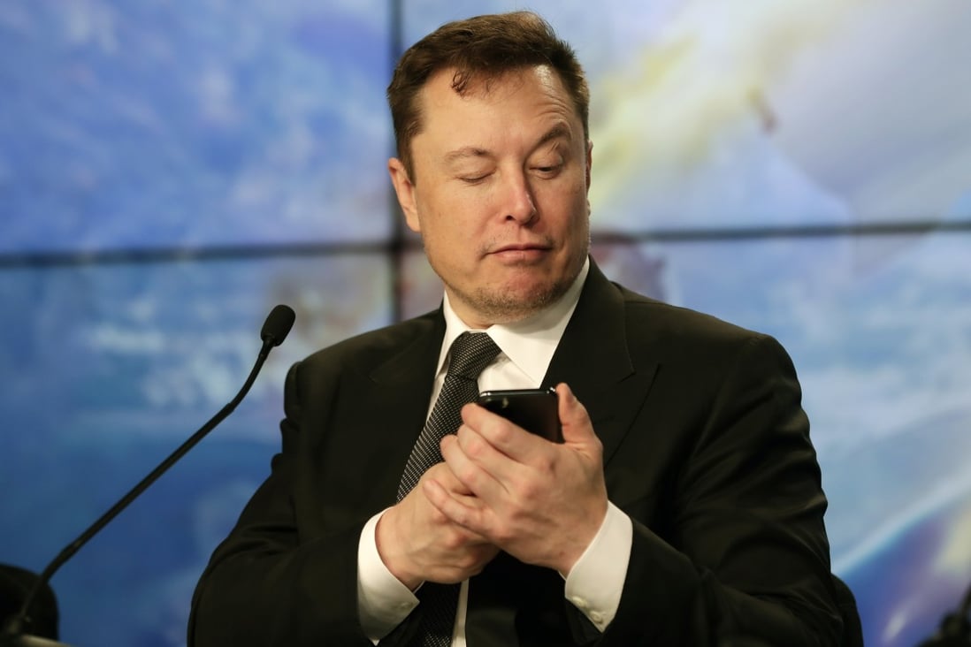 Elon Musk jokes with reporters as he pretends to search for an answer to a question on a mobile phone during a news conference at the Kennedy Space Centre in Cape Canaveral, Florida, in January 2020. Photo: AP