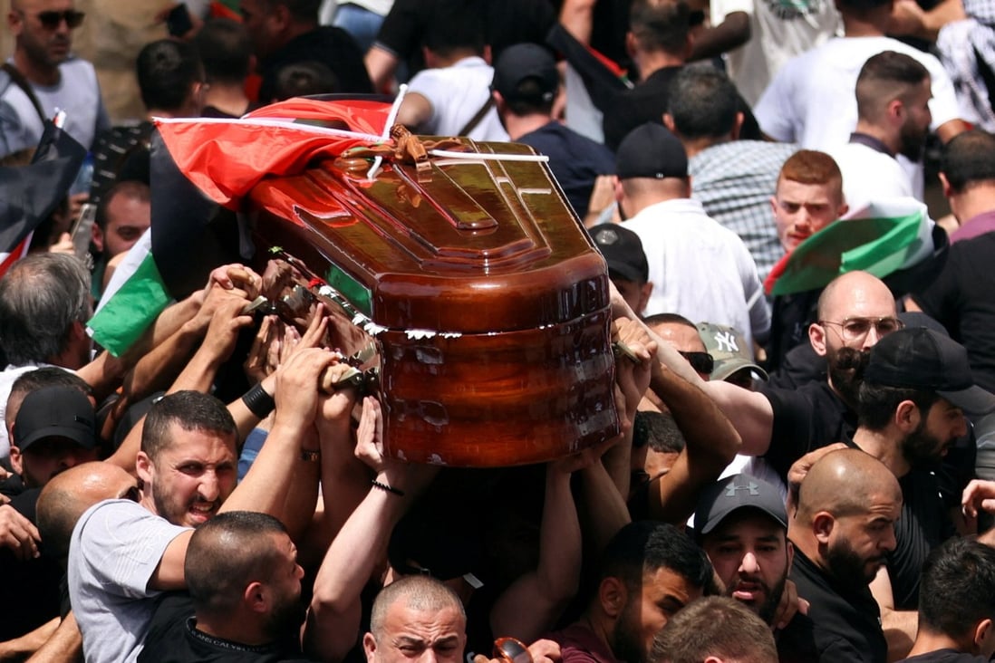 Family and friends carry the coffin of Al Jazeera reporter Shireen Abu Akleh as clashes erupted with Israeli security forces, during her funeral in Jerusalem, Israel on May 13. Photo: Reuters