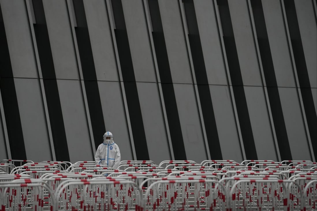 A worker in a protective suit stands watch near the barricades at a testing site as the authorities order a third round of coronavirus tests for residents of Beijing’s Chaoyang district on May 8. Photo: AP 