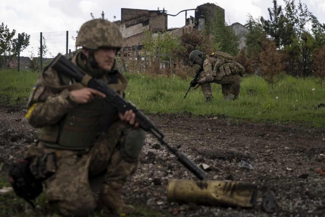Ukrainian servicemen on patrol in a recently retaken village, north of Kharkiv, east Ukraine. Photo: AP