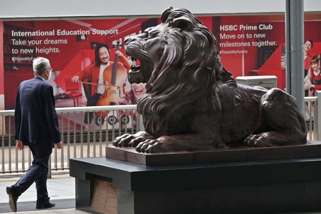 A pedestrian walks past the HSBC headquarters in Hong Kong on April 26, as the bank releases first quarter results. Photo: AFP
