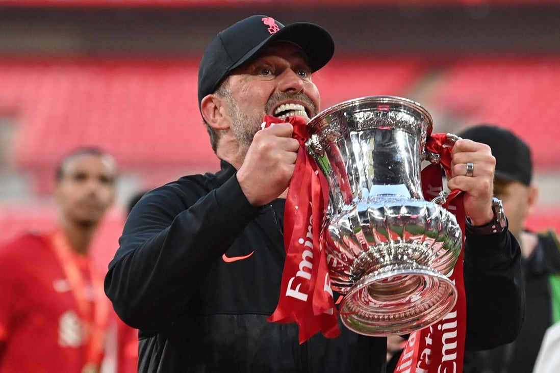 Liverpool manager Jurgen Klopp celebrates with the trophy after winning the English FA Cup final football match at Wembley stadium. Photo: AFP