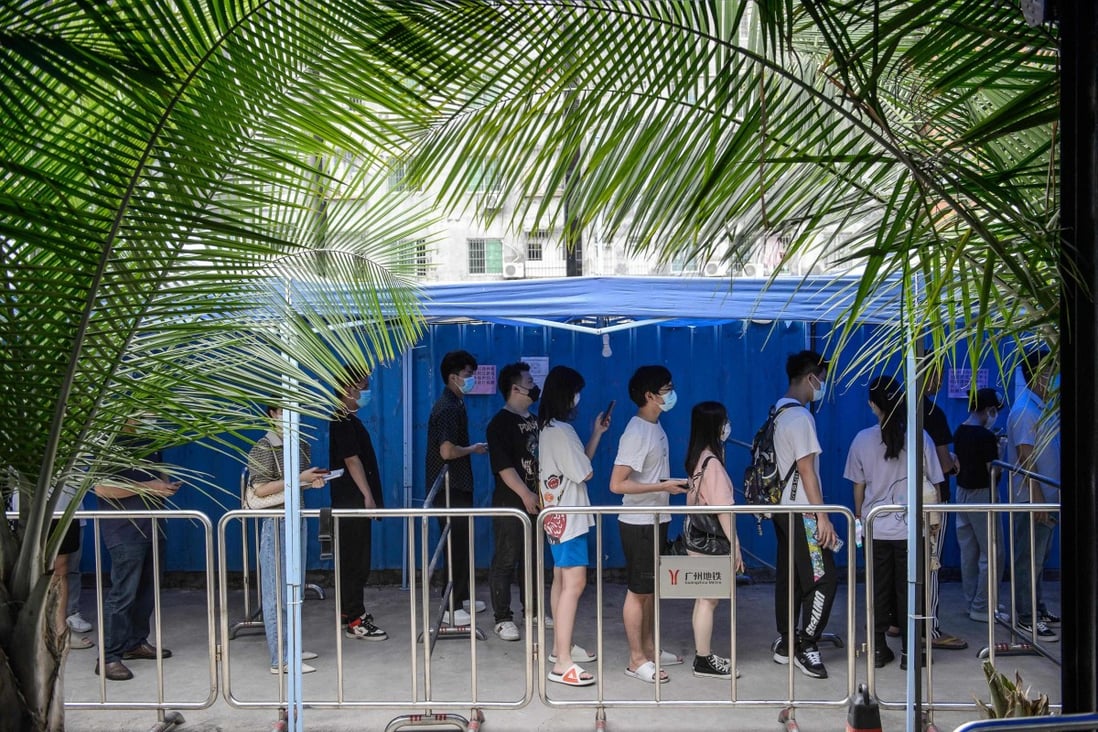 Residents queue up to get tested in Guangzhou. China is sticking to its zero-Covid policy and has plans for regular mass testing in big cities. Photo: AFP