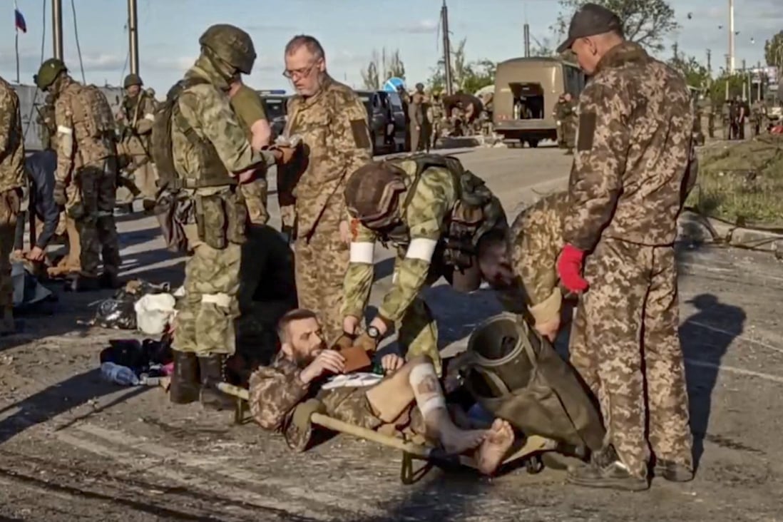 Russian servicemen frisk Ukrainian fighters evacuated from the besieged Azovstal steel plant in Mariupol, on Tuesday. Photo: Russian Defence Ministry Handout via EPA-EFE