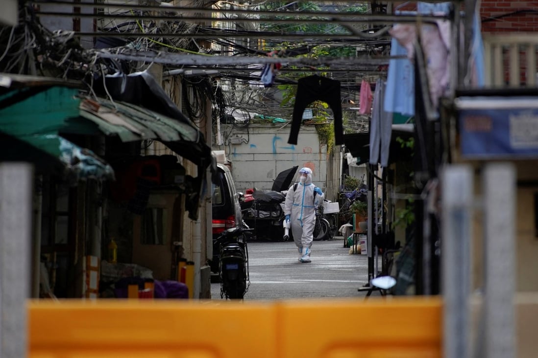 A worker in a protective suit disinfects a closed residential area in Shanghai during the city’s sixth week of Covid-19 lockdown. Photo: Reuters
