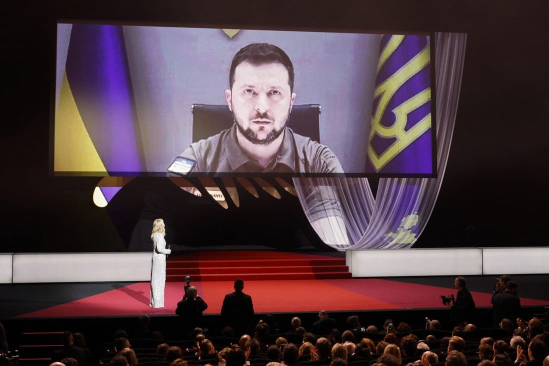 Ukraine’s President Volodymyr Zelensky is seen on a screen as he delivers a video address at the 75th Cannes Film Festival opening ceremony on Tuesday. Photo: Reuters