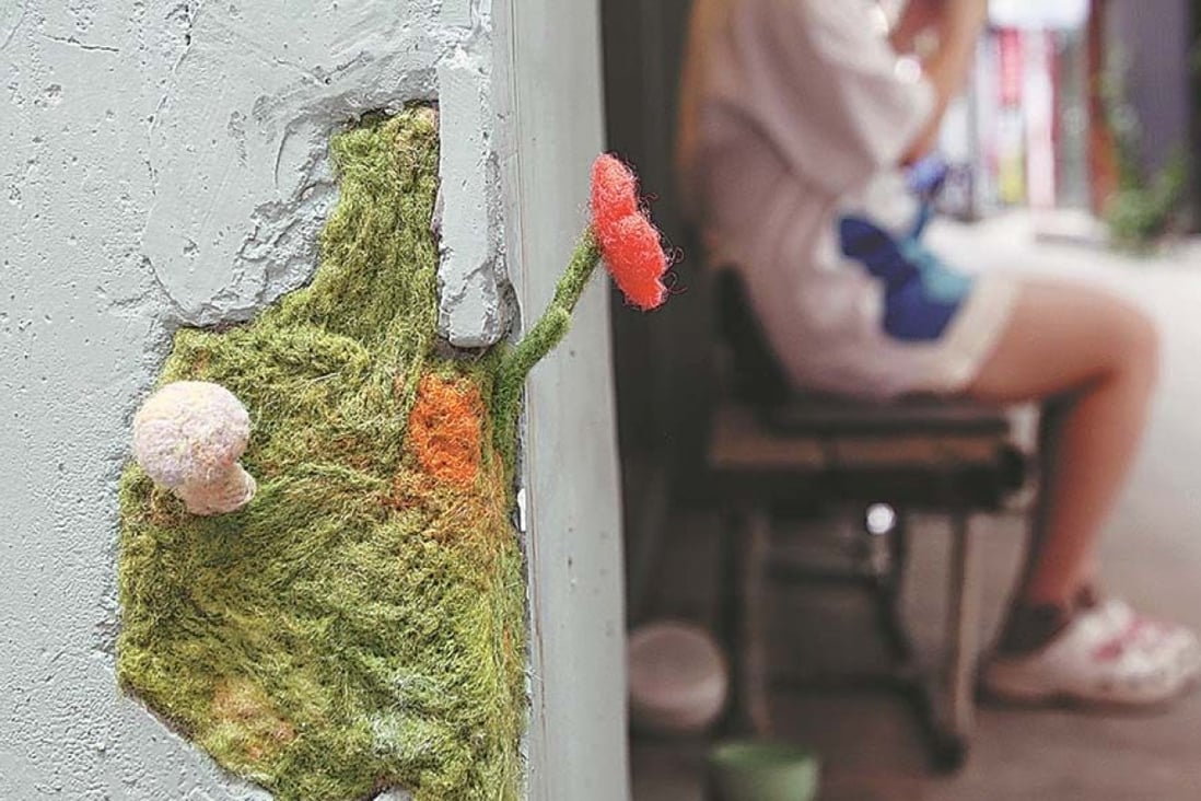 An artist in China has filled cracked walls with felt flowers. Photo: SCMP composite