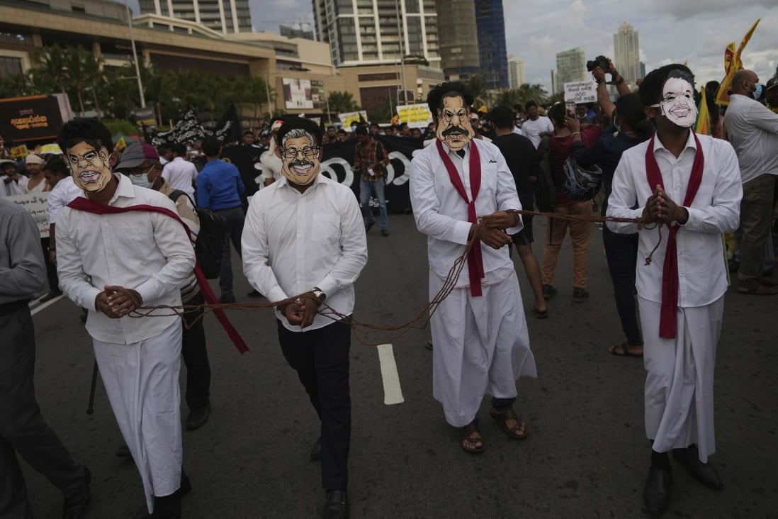 Sri Lankan protesters wear masks of president Gotabaya Rajapaksa’s family members during a march demanding Gotabaya resign. File photo: AP