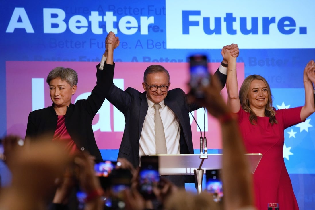 Labor Party leader Anthony Albanese (centre) celebrates with his partner partner Jodie Haydon, (right) and Labor senate leader Penny Wong at a Labor Party event in Sydney on Sunday. Photo: AP