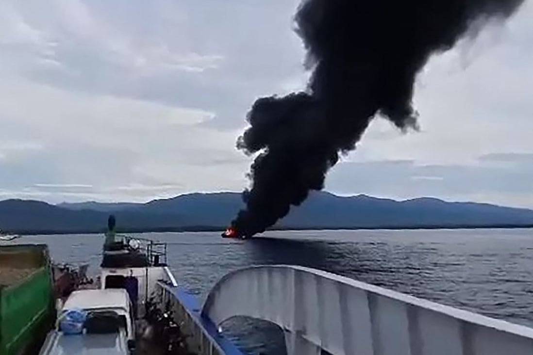 Black smoke rises from the burning ferry. Photo:  Kycel Pineda / AFP