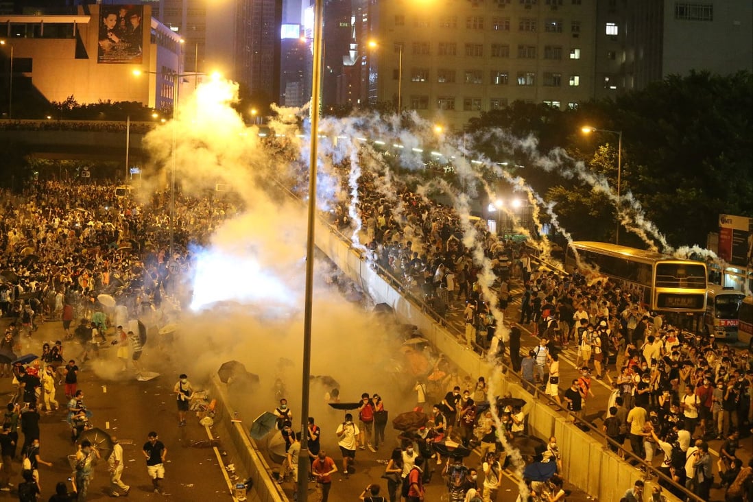Police in riot gear fire tear gas at Occupy Central protesters in Connaught Road Central, Admiralty. Yesterday was the first time tear gas had been deployed by Hong Kong police since 2005. Photo: K.Y. Cheng