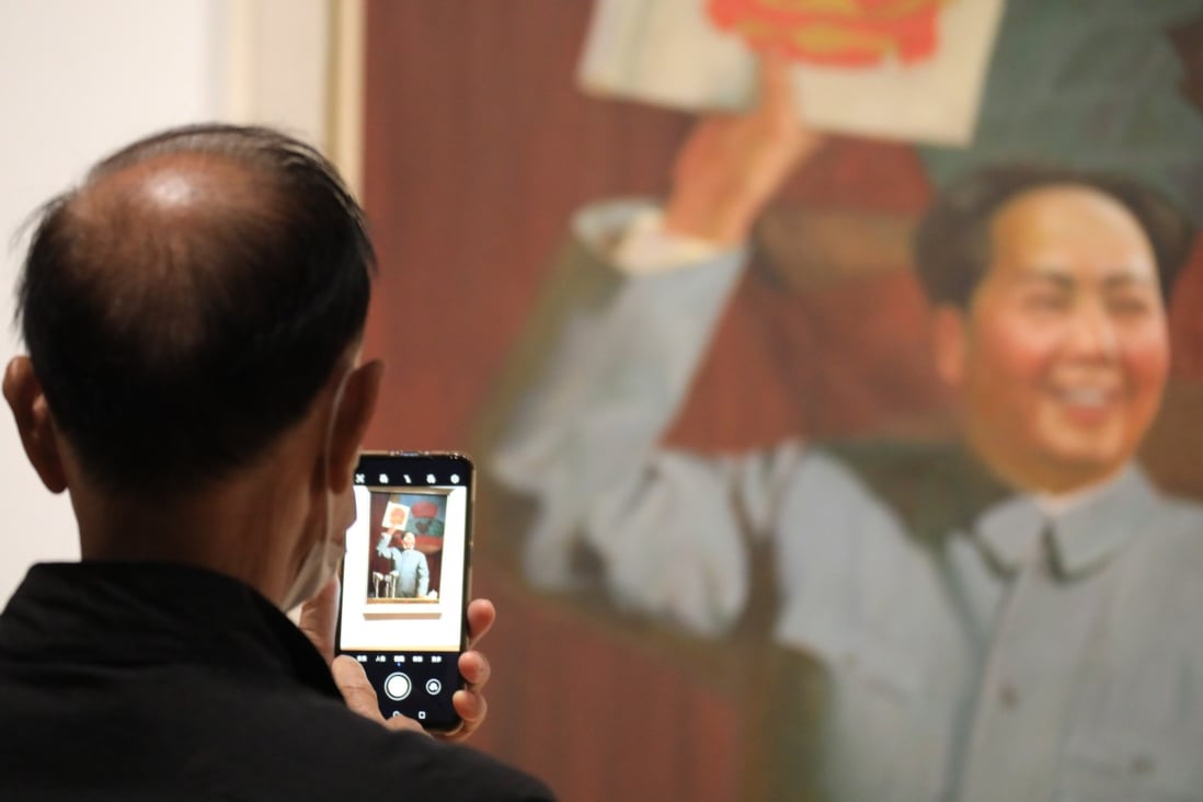 A man enjoys an artwork featuring Mao Zedong at the M+ museum in the West Kowloon Cultural District. Photo: Felix Wong