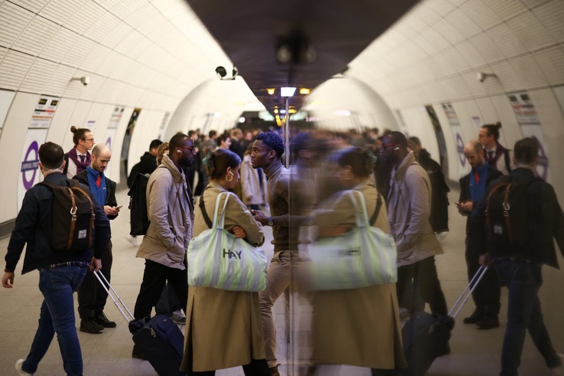 Passengers board an Elizabeth Line train at Liverpool Street underground station. Photo: Reuters