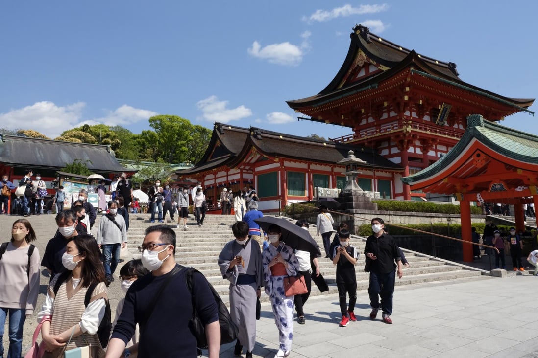 Tourists at an entrance of Fushimi Inari shrine in Kyoto, Japan. Photo: Bloomberg
