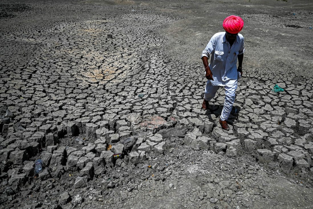 A villager walks through a dried-up pond during India’s early heatwave. Photo: Getty Images