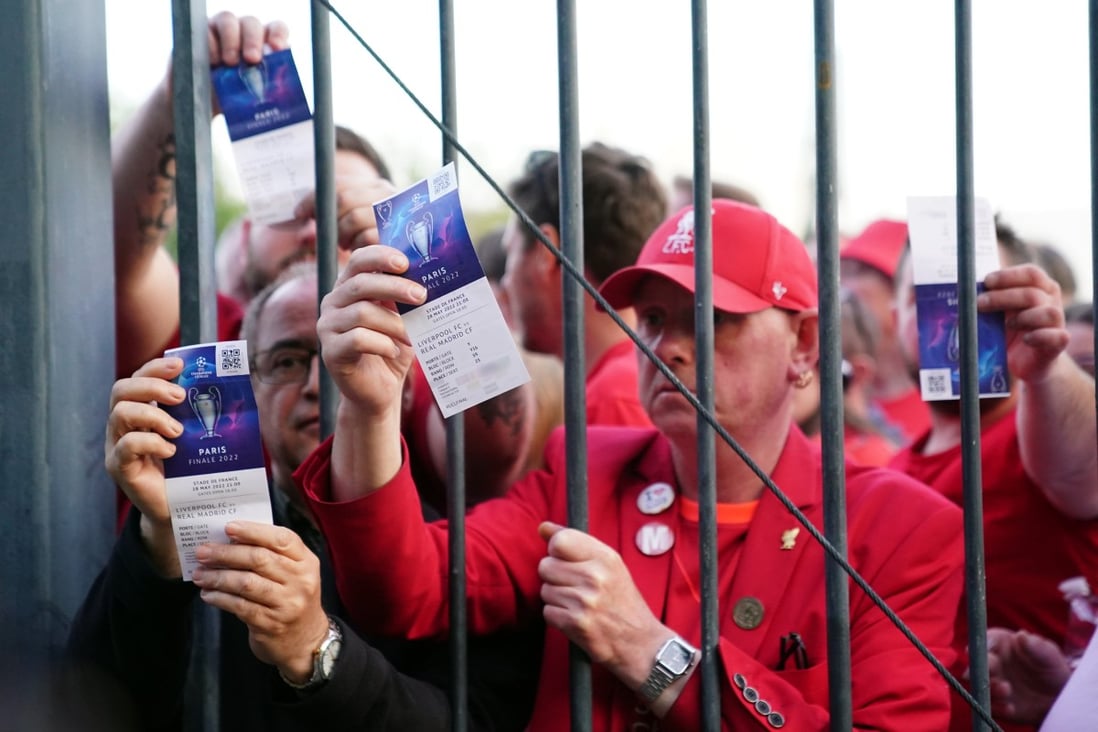 Liverpool fans stuck outside the ground as they show their match tickets before the Uefa Champions League final between Liverpool and Real Madrid at the Stade de France in Paris on May 28. Photo: PA Wire / DPA