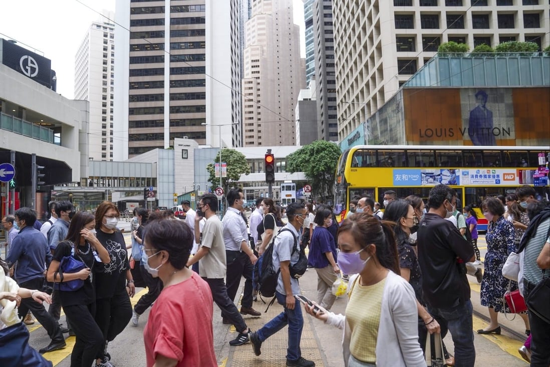 People crossing the street at Central district on October 7, 2021. Hong Kong consumers have become more health conscious during the most recent coronavirus wave, helping boost insurance sales in the first quarter. Photo: SCMP / Sam Tsang