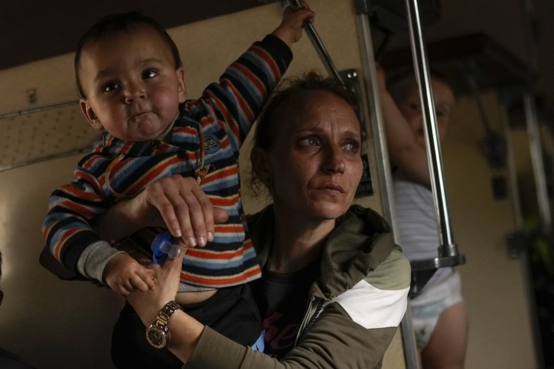 Yana Skakova and her son Yehor who fled from Lysychansk with other people sit in an evacuation train at the train station in Pokrovsk, eastern Ukraine. Photo: AP
