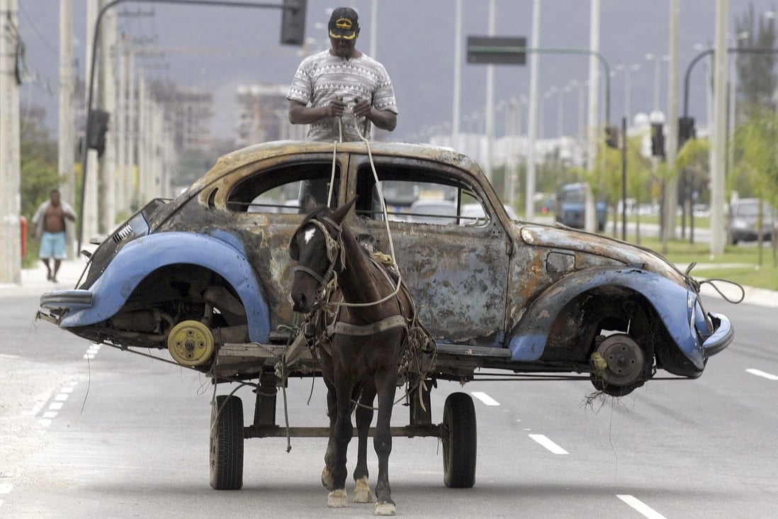 A Brazilian man transports on his horse-drawn cart the remains of a Volkswagen Beetle in Rio de Janeiro, Brazil. Photo: Reuters