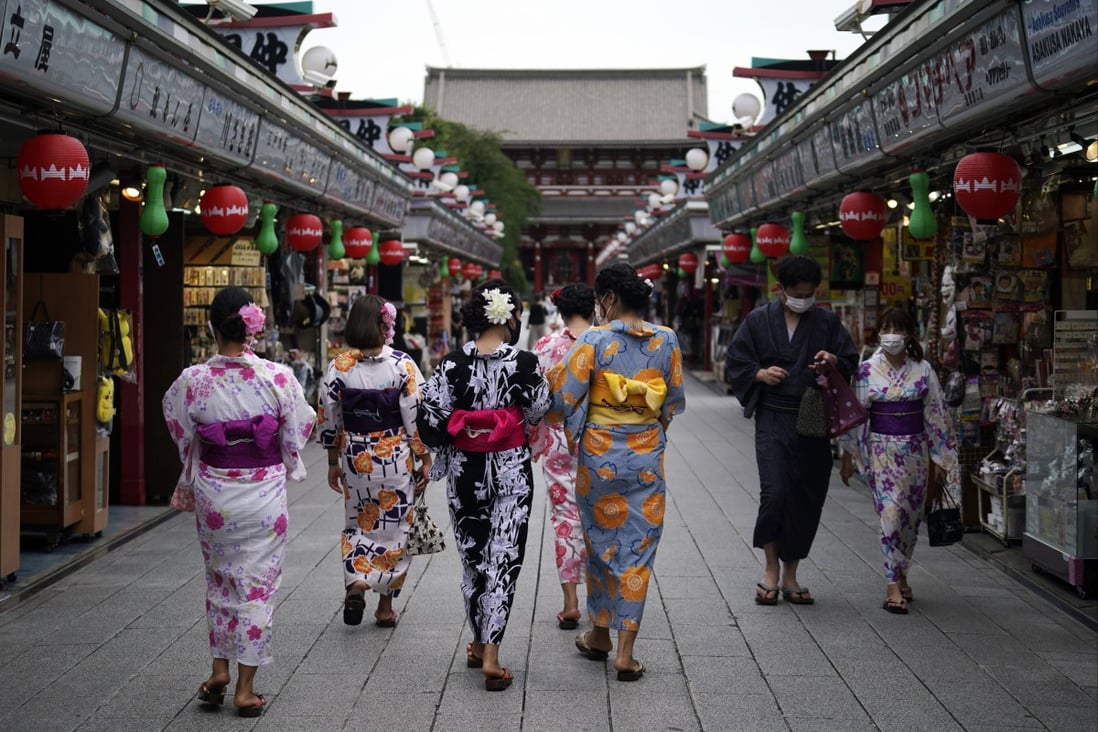 Tourists in traditional Japanese kimonos in Tokyo; there are concerns about Covid-19 spike as Japan opens its borders. Photo: AP 