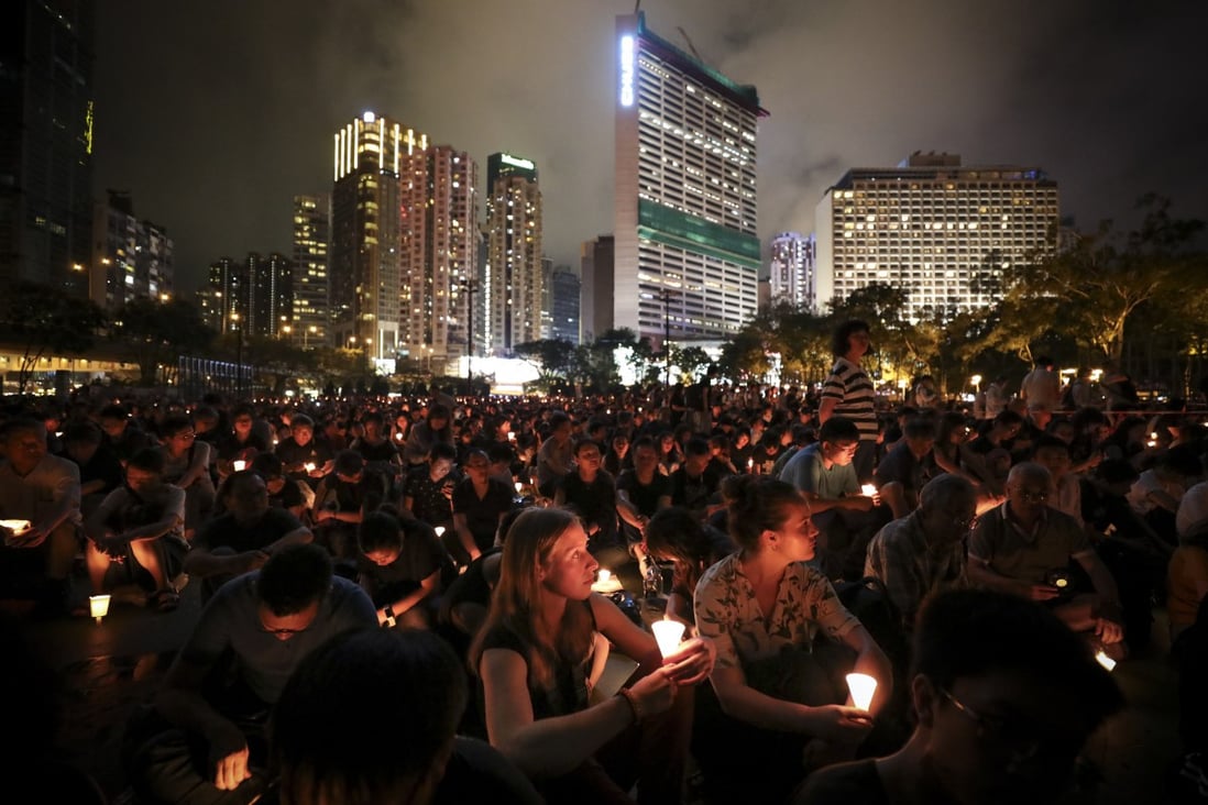 Crowds in 2019 hold up candles in a June 4 vigil at Victoria Park. The event has since been banned on health grounds. Photo: James Wendlinger