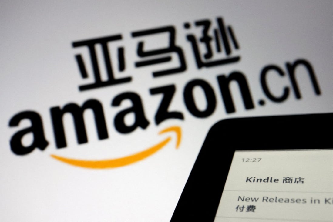 The logo of Amazon China is seen next to a Kindle e-reader, December 15, 2021. Photo: Reuters