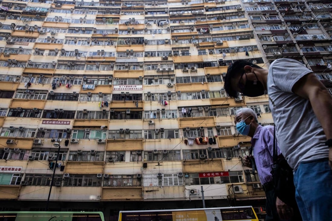 People walk past a residential apartment block in Hong Kong on May 20. The shortage of affordable housing and continuous surge in prices in the private market have made home ownership out of reach for many Hongkongers. Photo: AFP