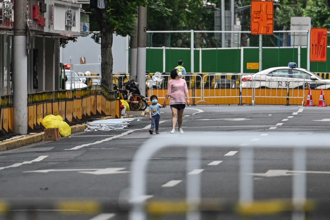 Residents walk on a blocked street in a residential area under a Covid-19 lockdown in the Jing’an district of Shanghai on June 3, 2022. Photo: AFP