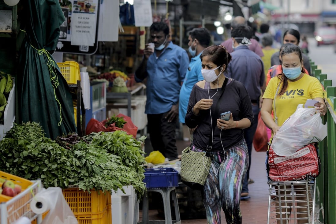 People at a vegetable stall in Singapore. Photo: EPA-EFE