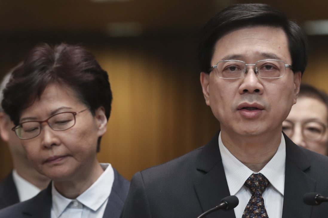 Chief Executive Carrie Lam listens as then secretary for security John Lee speaks to the media at the Chief Executive’s Office in Tamar on July 21, 2019. Photo: Robert Ng