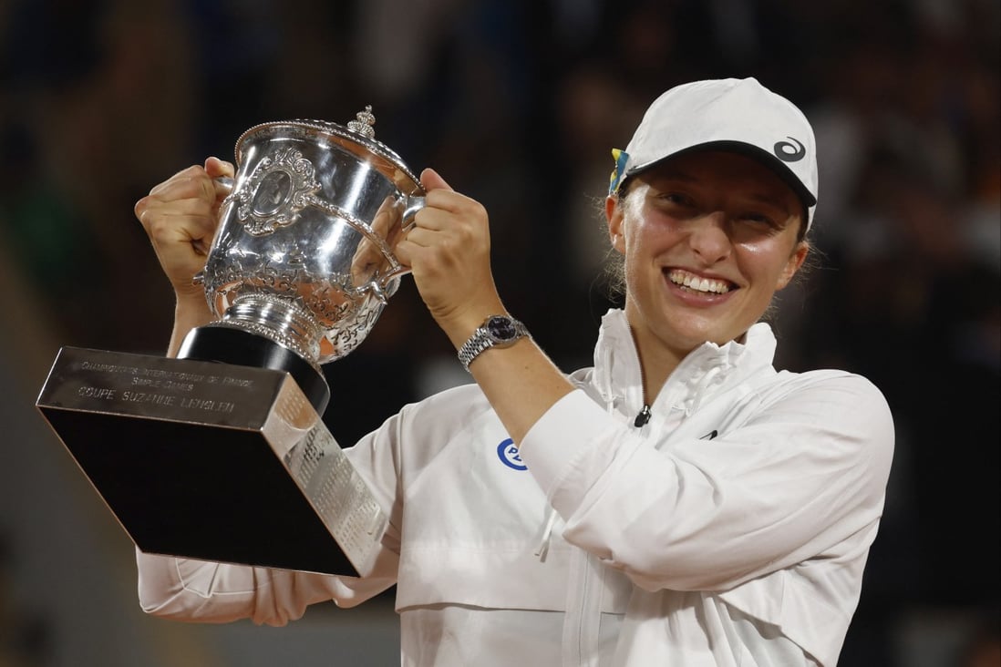 Iga Swiatek celebrates with the trophy after winning the women’s singles final. Photo: Reuters