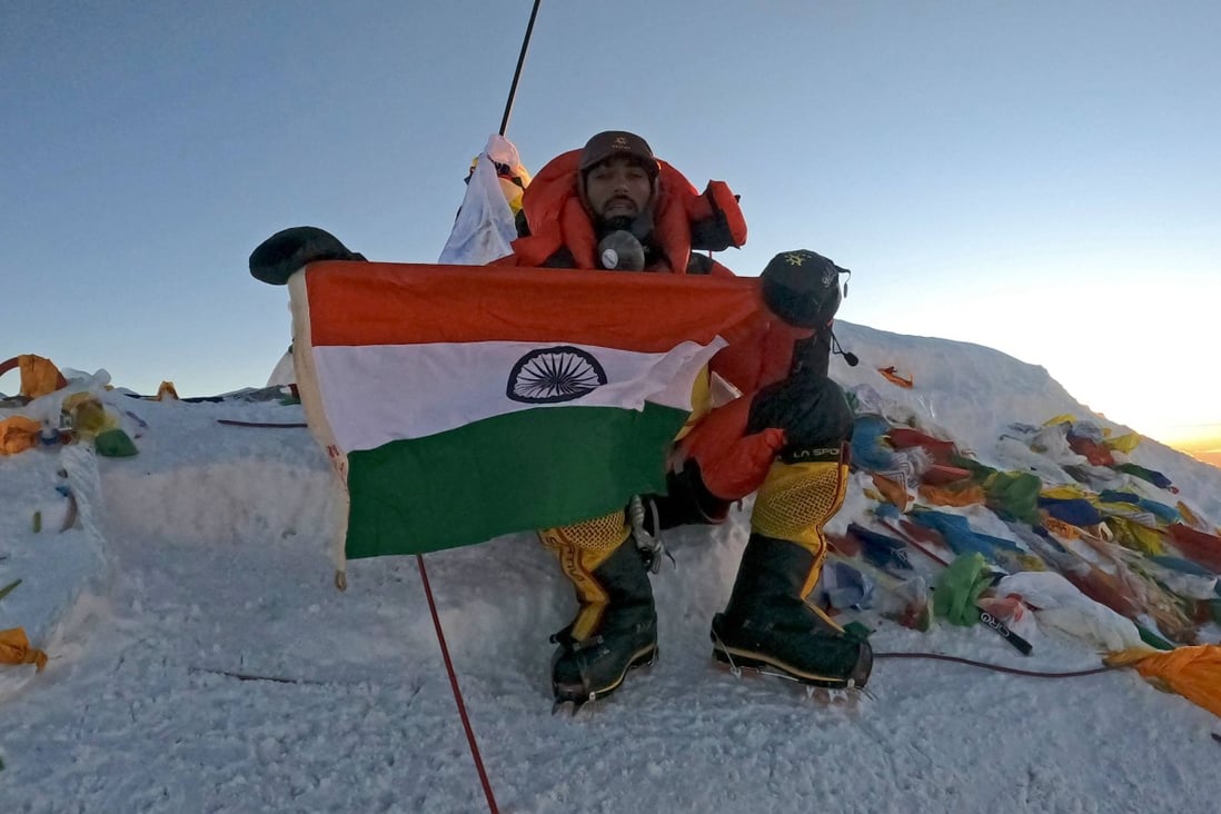 Narender Singh Yadav poses with India’s national flag at the summit of Mount Everest on May 27. Photo: Pioneer Adventure Pvt Ltd / AFP